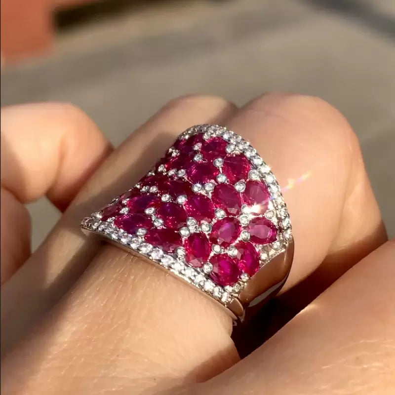 25.5ctw Oval Shaped Ruby Saddle Ring with Diamond Prongs