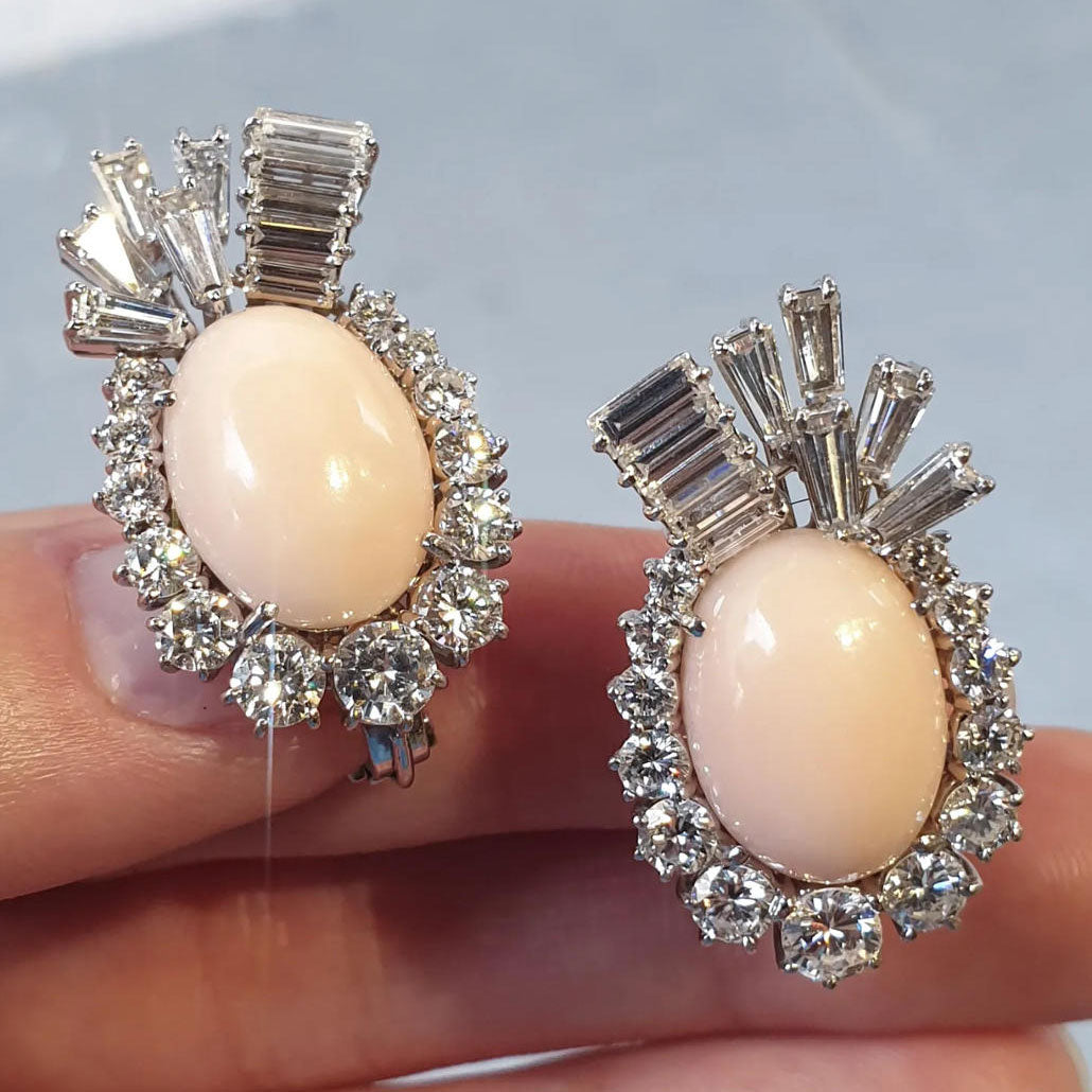 Vintage-style cocktail ring and earring set featuring oval pink coral and sapphires